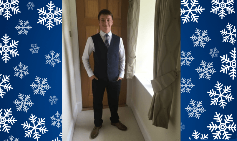 18 year old Andy, smiling and healthy, dressed in a suit for prom.