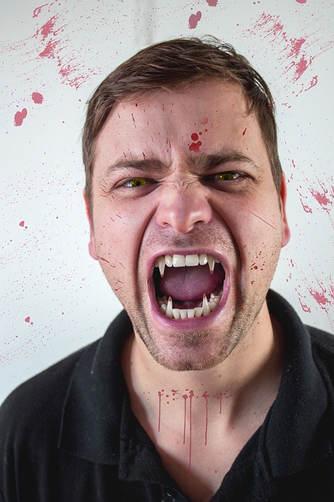 Vampire exposing fanged teeth. 