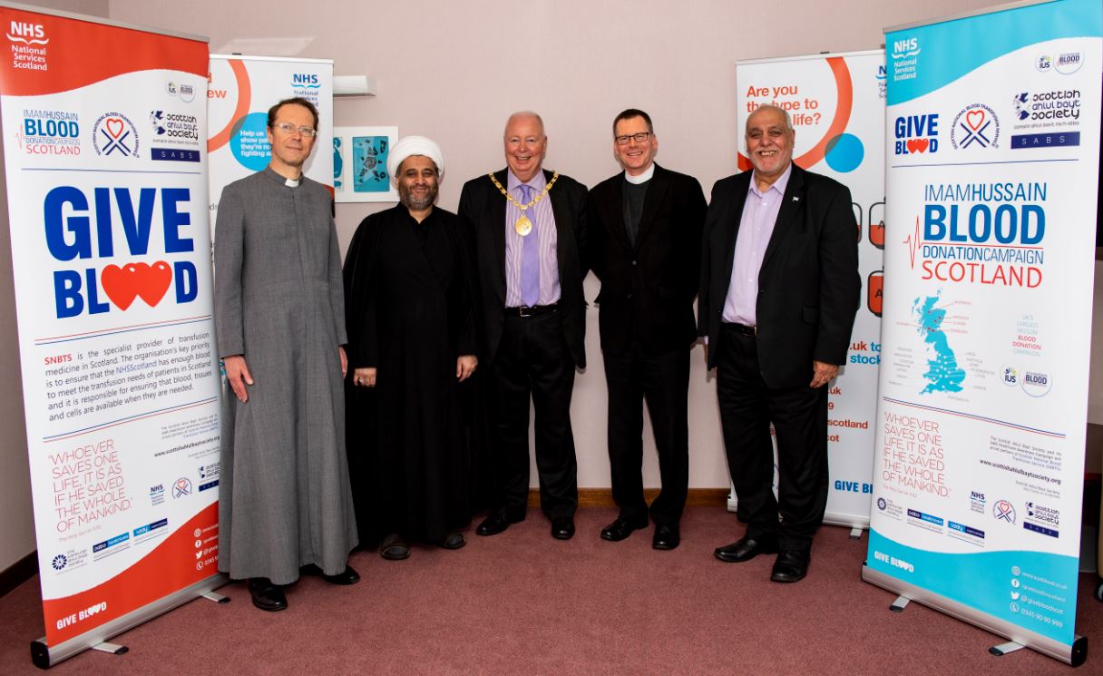 Group photo of faith leaders standing with East Renfrewshire Provost for photograph. 