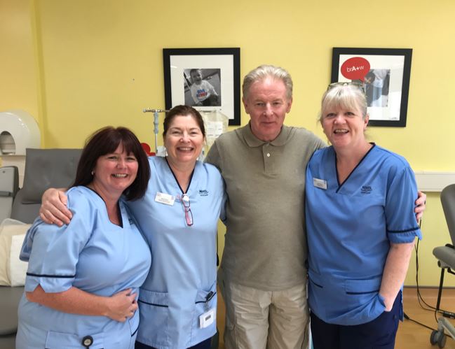 Donor Douglas stands for a group photo with nurses. 