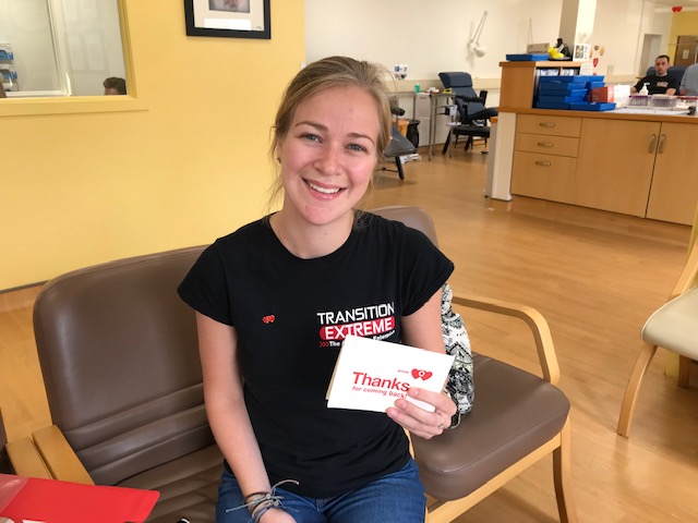 Linzi proudly holds her blood type badge. 